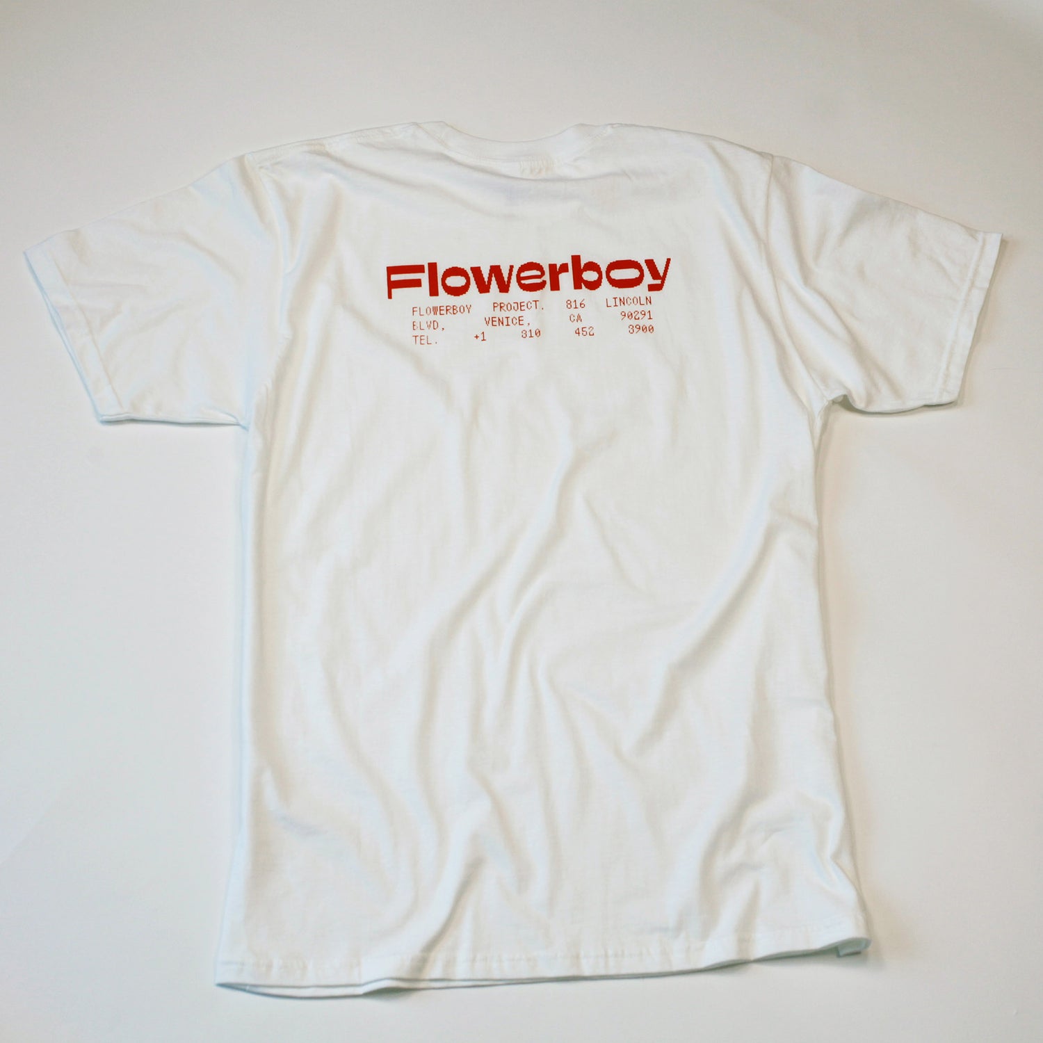 Flowerboy Project white short sleeve t-shirt with red print on the back with our digital Flowerboy logo and our store address in Venice Beach. This image is of the back of the tee.